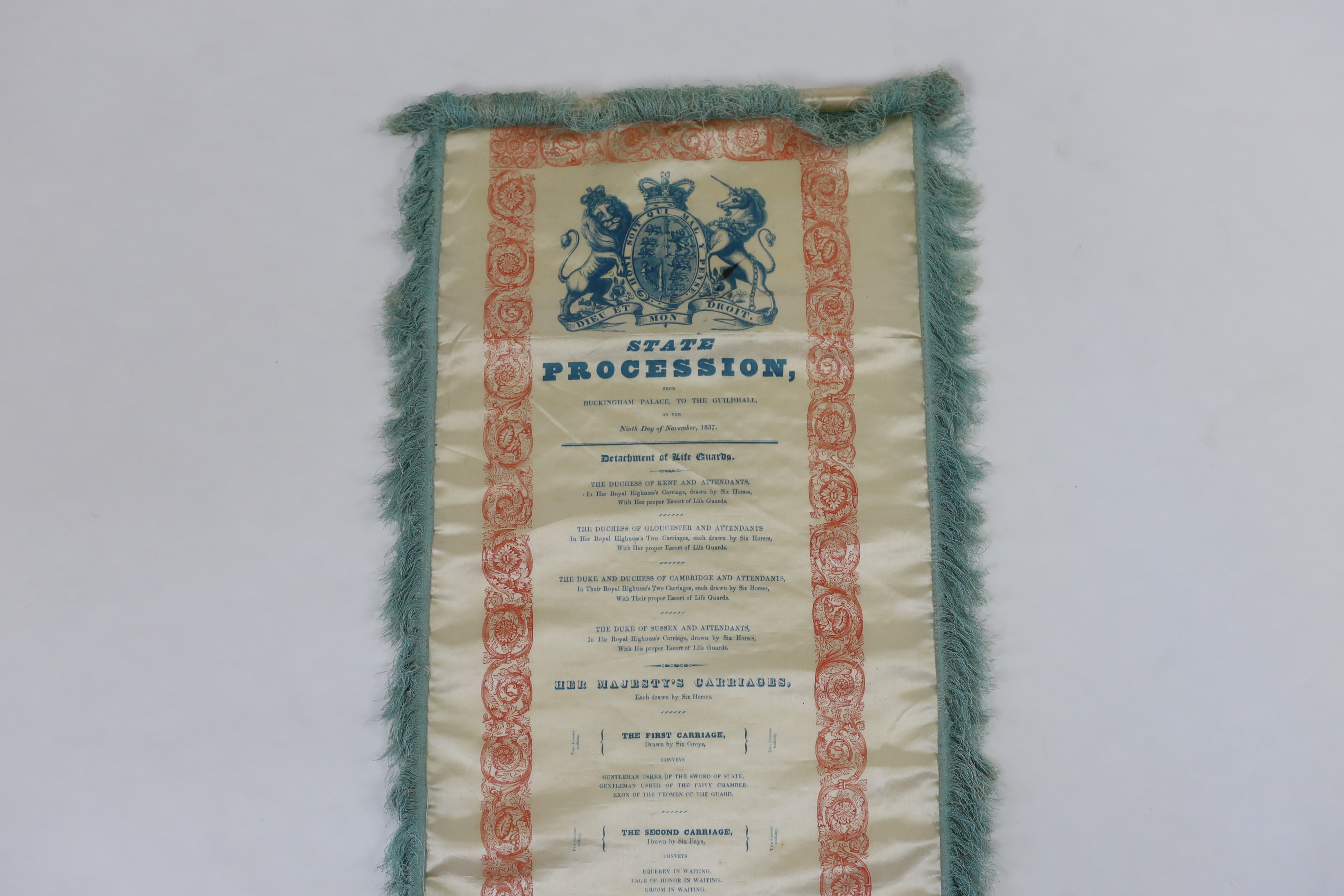 A silk banner; State Procession from Buckingham Palace to The Guildhall on the Ninth Day of November 1837. The day of Queen Victoria’s Coronation. Printed with the Royal Coat of Arms and a list of the guards, carriages a